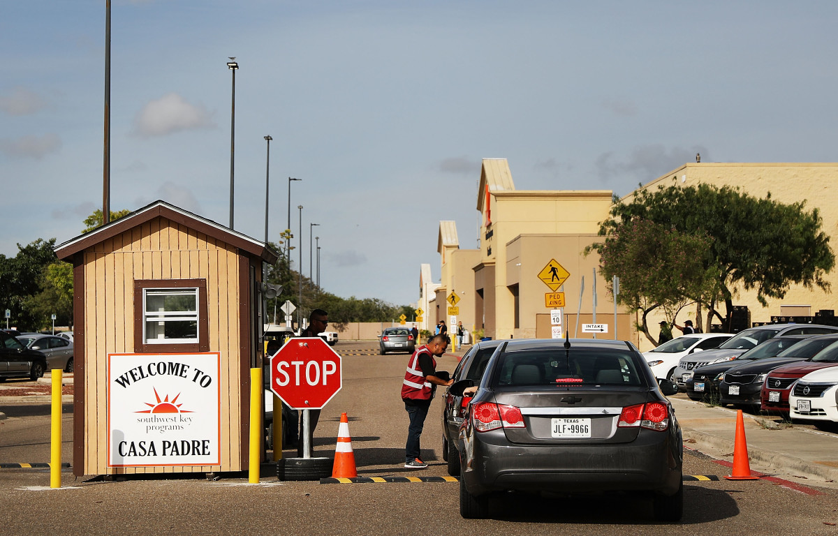 A security guard checks cars at the entrance to Casa Padre, a former Walmart that is now a center for unaccompanied immigrant children, on June 24th, 2018, in Brownsville, Texas.