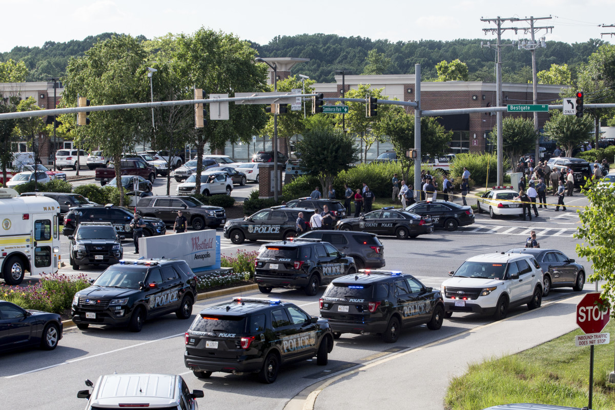 Police respond to a shooting on June 28th, 2018, in Annapolis, Maryland. At least five people were killed Thursday when a gunman opened fire inside the offices of the Capital Gazette, a newspaper published in Annapolis, a historic city an hour east of Washington. A reporter for the daily, Phil Davis, tweeted that a "gunman shot through the glass door to the office and opened fire on multiple employees. There is nothing more terrifying than hearing multiple people get shot while you're under your desk and then hear the gunman reload."
