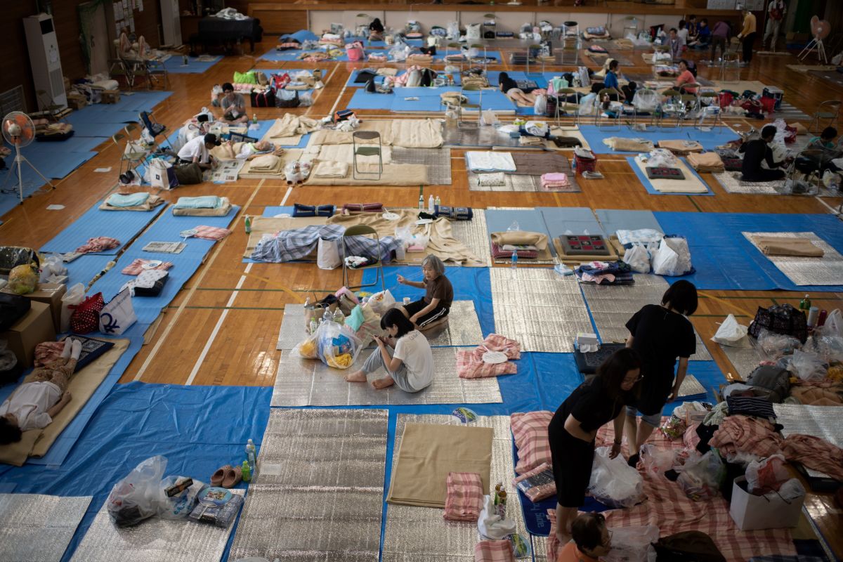 People affected by the recent flooding rest at a makeshift shelter in Mabi, Okayama prefecture, Japan, on July 11th, 2018.