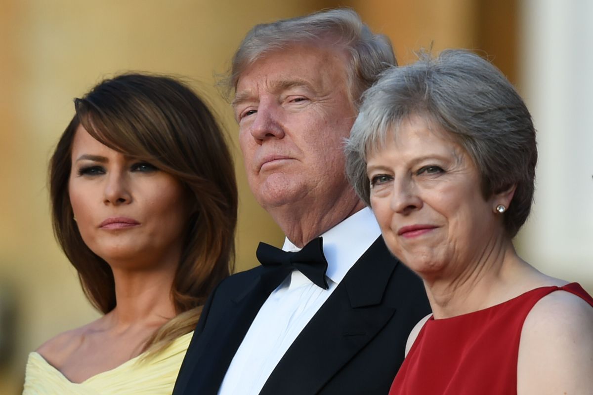 U.S. First Lady Melania Trump, President Donald Trump, and Britain's Prime Minister Theresa May stand on the steps in the Great Court on the first day of Trump's visit to the United Kingdom.