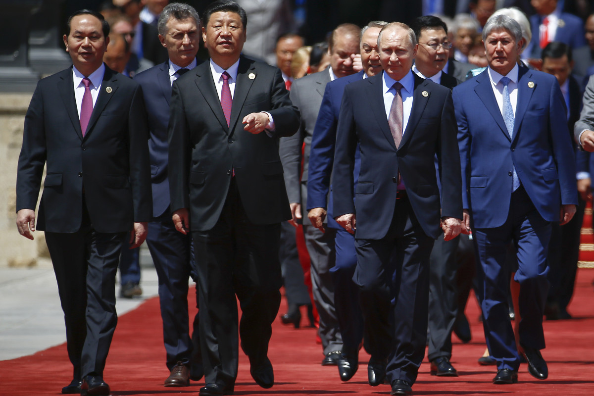 Chinese President Xi Jinping and Russian President Vladimir Putin arrive with other leaders for a family photo during the Belt and Road Forum.