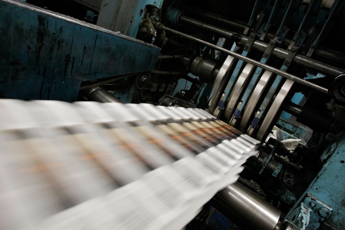 Freshly printed copies of the San Francisco Chronicle roll off the printing press.