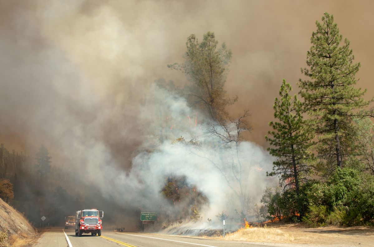 Fire trucks pass by approaching flames during the Carr fire near Whiskeytown, California, on July 27th, 2018.