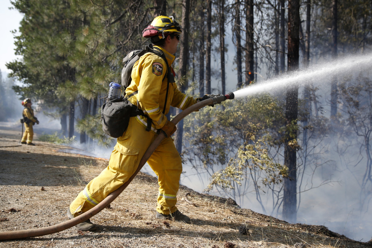 A firefighter extinguishes flames while battling the Carr fire on July 30th, 2018, near Redding, California.