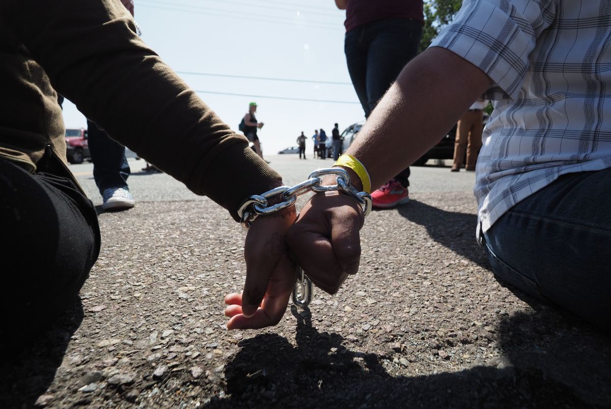 Protesters chained together at the wrist block traffic from passing on the road to the Otay Mesa Detention Center during a demonstration against U.S. immigration policy that separates children from parents, in San Diego, California, on June 23rd, 2018.