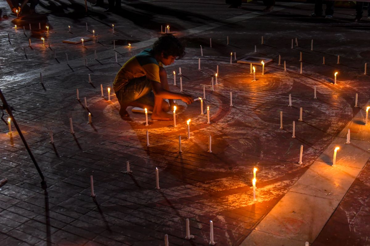 A Bangladeshi child lights a candle to mark International Day of the World's Indigenous Peoples in Dhaka on August 8th, 2018. International Day of the World's Indigenous Peoples takes place on August 9th to promote and protect the rights of indigenous communities and cultures.