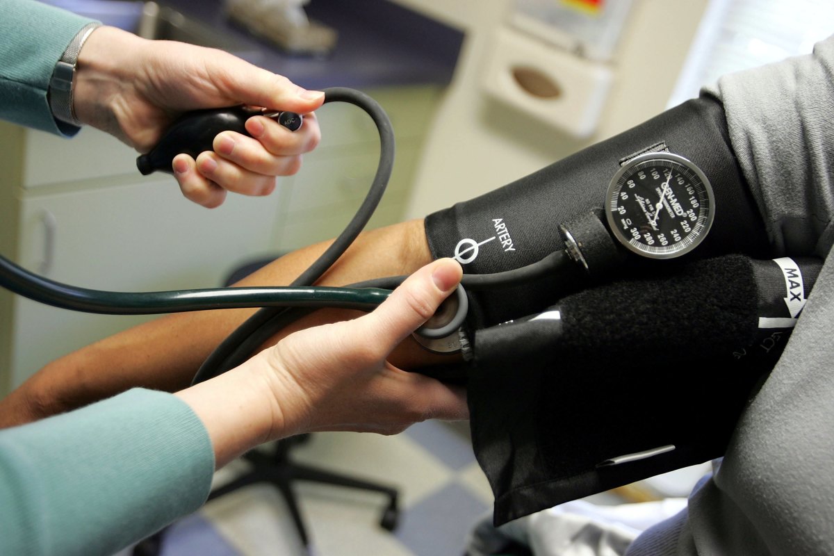 Dr. Elizabeth Maziarka reads a blood pressure gauge during an examination of patient June Mendez at the Codman Square Health Center on April 11th, 2006, in Dorchester, Massachusetts.
