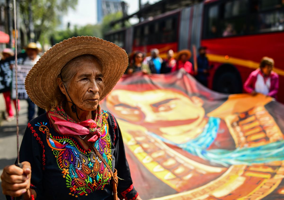 People from San Salvador Atenco, a town outside of Mexico City, protest the construction of a new international airport on August 14th, 2018. For years, residents of the semi-rural town have fought against plans to construct the the Mexican capital's new airport adjacent to their town, fearing that the construction will result in their displacement. On Tuesday, protesters sought to pressure President-Elect Andrés Manuel López Obrador to commit to his campaign promise to cancel the airport's construction (the president-elect has since vacillated on the promise). In this photo, a woman holds a machete and marches in front of a banner bearing the image of Emiliano Zapata, a hero of the Mexican Revolution who famously sought to return land rights to indigenous people in the country's south.