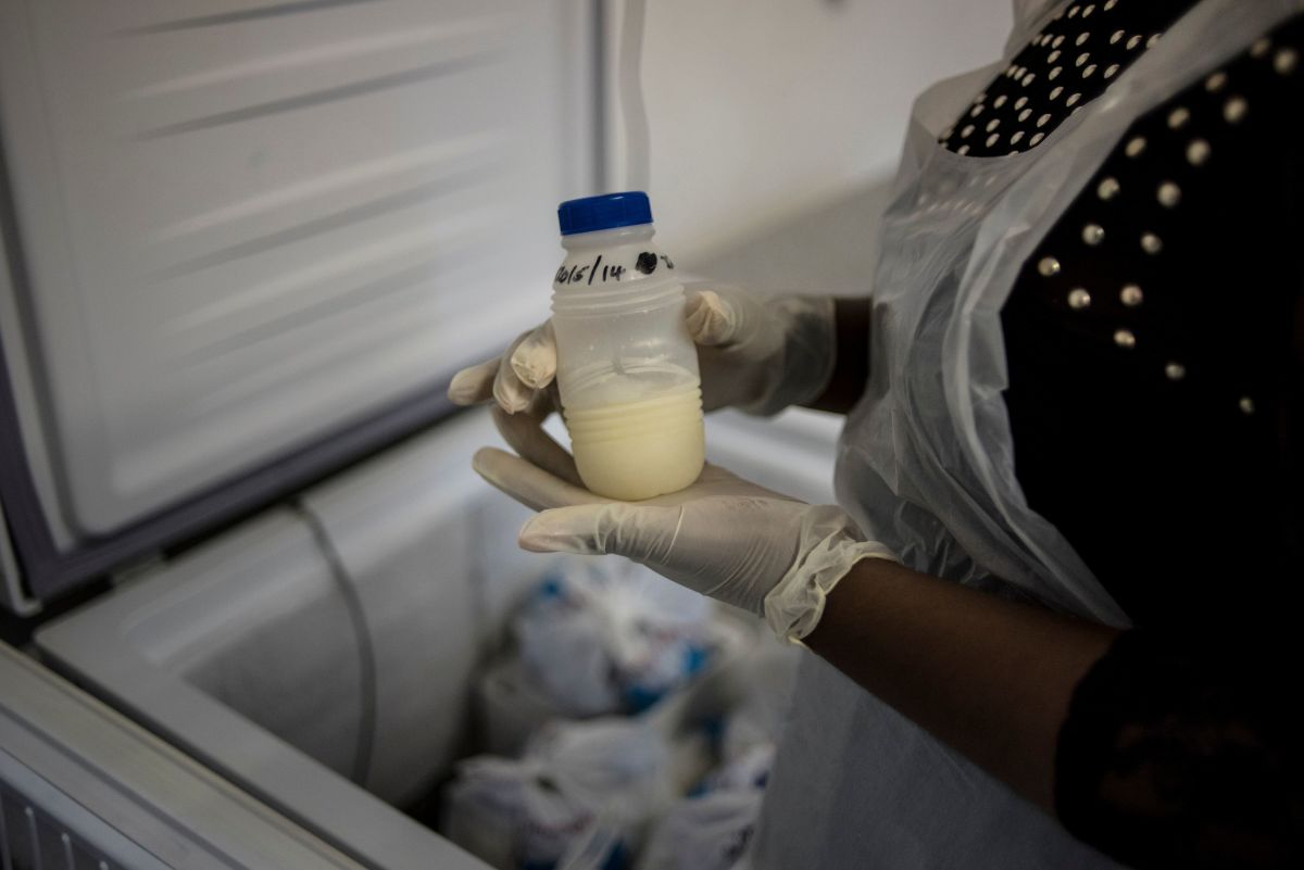 A staff member of the South African Breastmilk Reserve in Johannesburg holds a bottle of pasteurized breast milk.