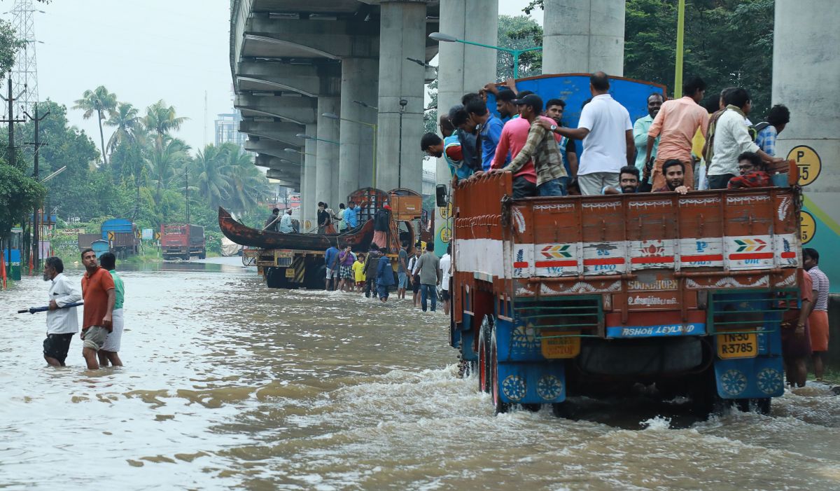 Indian commuters travel in a truck to a safer place as flood waters ravage the National Highway 47 in the Ernakulam district of Kochi, in the Southern Indian state of Kerala, on August 16th, 2018. According to the BBC, the death toll from floods in Kerala rose to over 100 on August 16th as torrential rainfall threatened new areas.