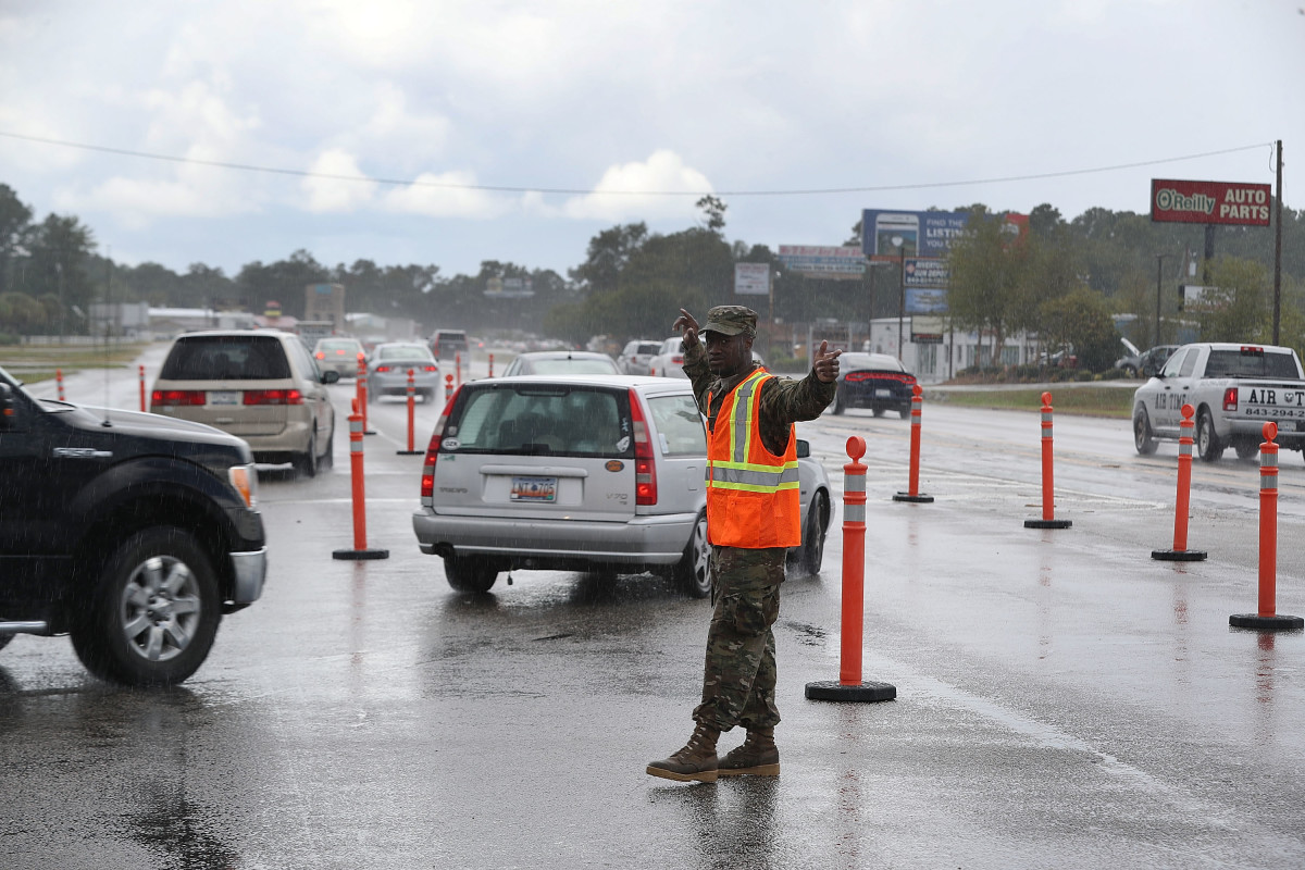 Traequan Shaw of the South Carolina National Guard directs traffic onto U.S. 501 in Myrtle Beach after the South Carolina government ordered that traffic use all the lanes on the route leading away from the coast to facilitate evacuation ahead of the arrival of Hurricane Florence on September 11th, 2018.