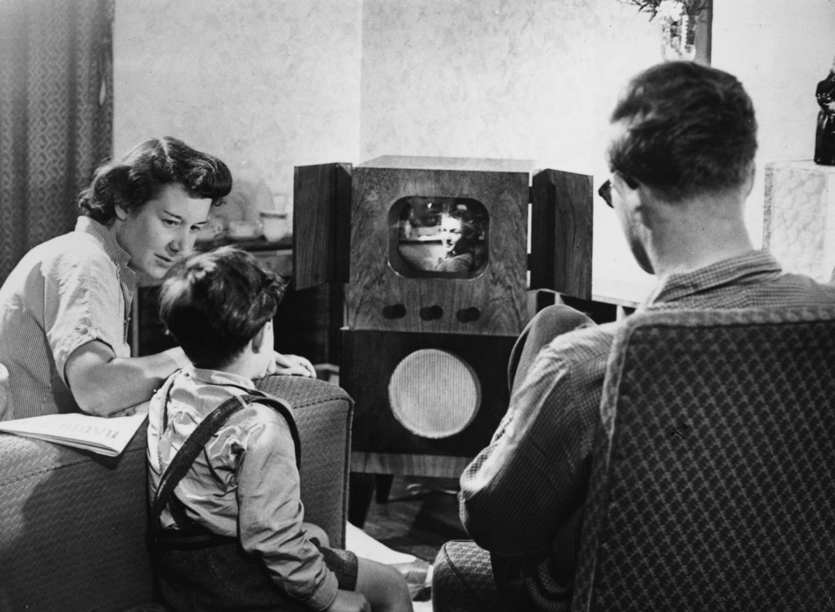 A family watching television at home, circa 1955.
