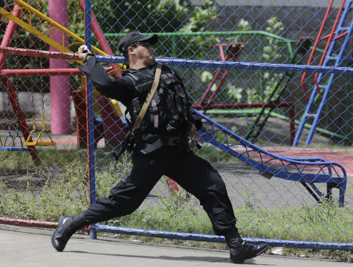 A riot policeman throws a sound grenade during clashes against protestors demonstrating against Nicaraguan President Daniel Ortega's government in Managua, on September 23rd, 2018.