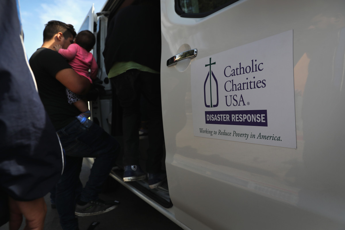 An immigrant family from Honduras boards transport to an Immigrant Respite Center near McAllen, Texas.