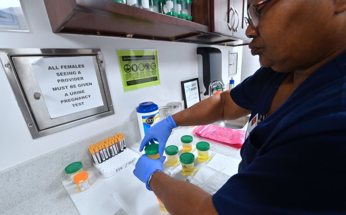 A medical assistant closes bottles of patients' urine submitted for STD testing in Hollywood, California, on May 18th, 2018.