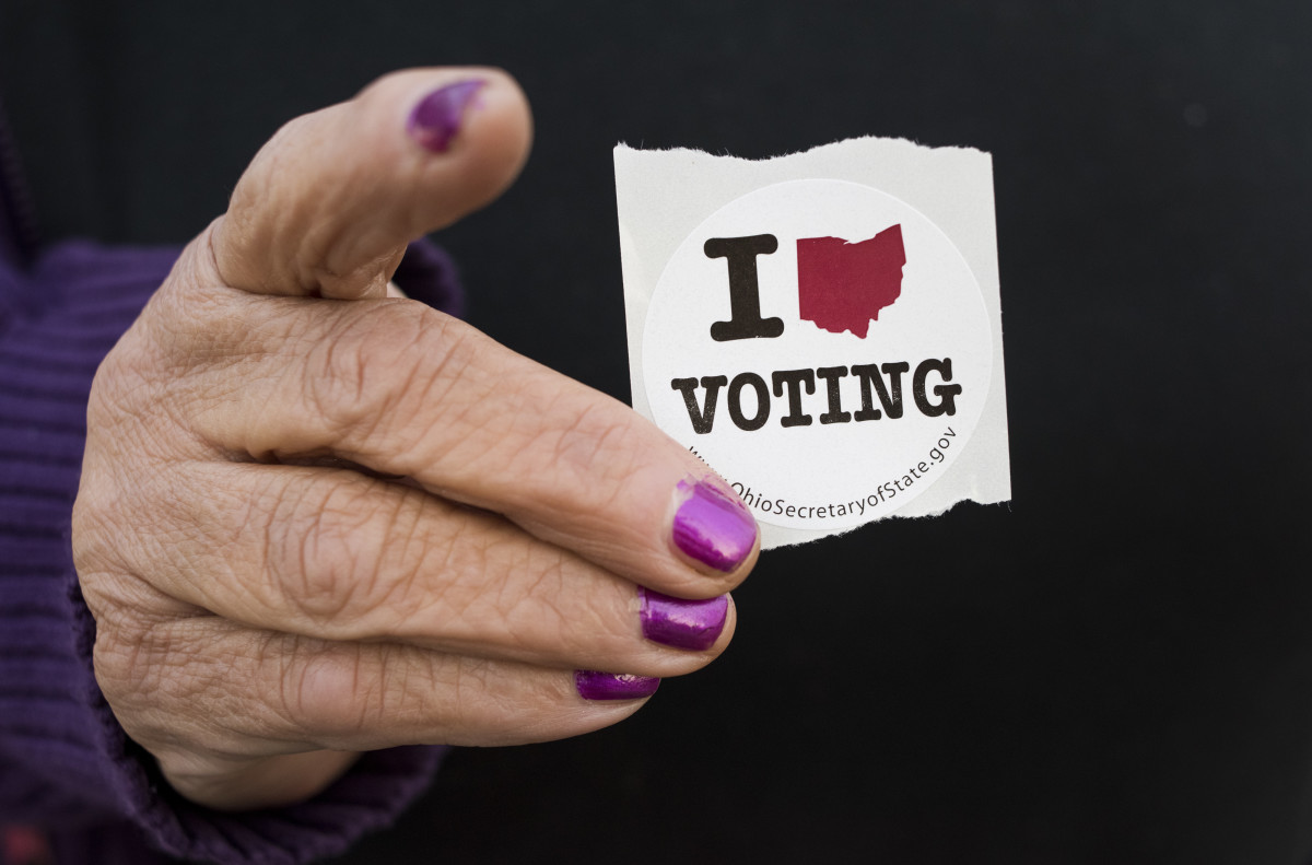 A woman holds her voting sticker in her hand after casting her ballot in Leetonia, Ohio.