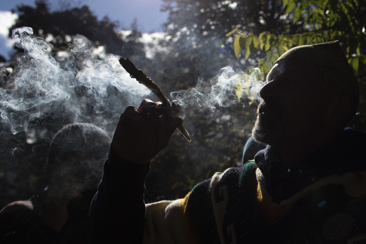 A man smokes marijuana during a legalization party at Trinity Bellwoods Park in Toronto, Ontario, on October 17th, 2018. Nearly a century of marijuana prohibition came to an end Wednesday as Canada became the first major Western nation to legalize and regulate its sale and recreational use. Scores of customers braved the cold for hours outside Tweed, a pot boutique in St John's, Newfoundland, that opened briefly at midnight, to buy their first grams of legal cannabis. In total, Statistics Canada says 5.4 million Canadians will buy cannabis from legal dispensaries in 2018—about 15 percent of the population. Around 4.9 million already smoke marijuana.