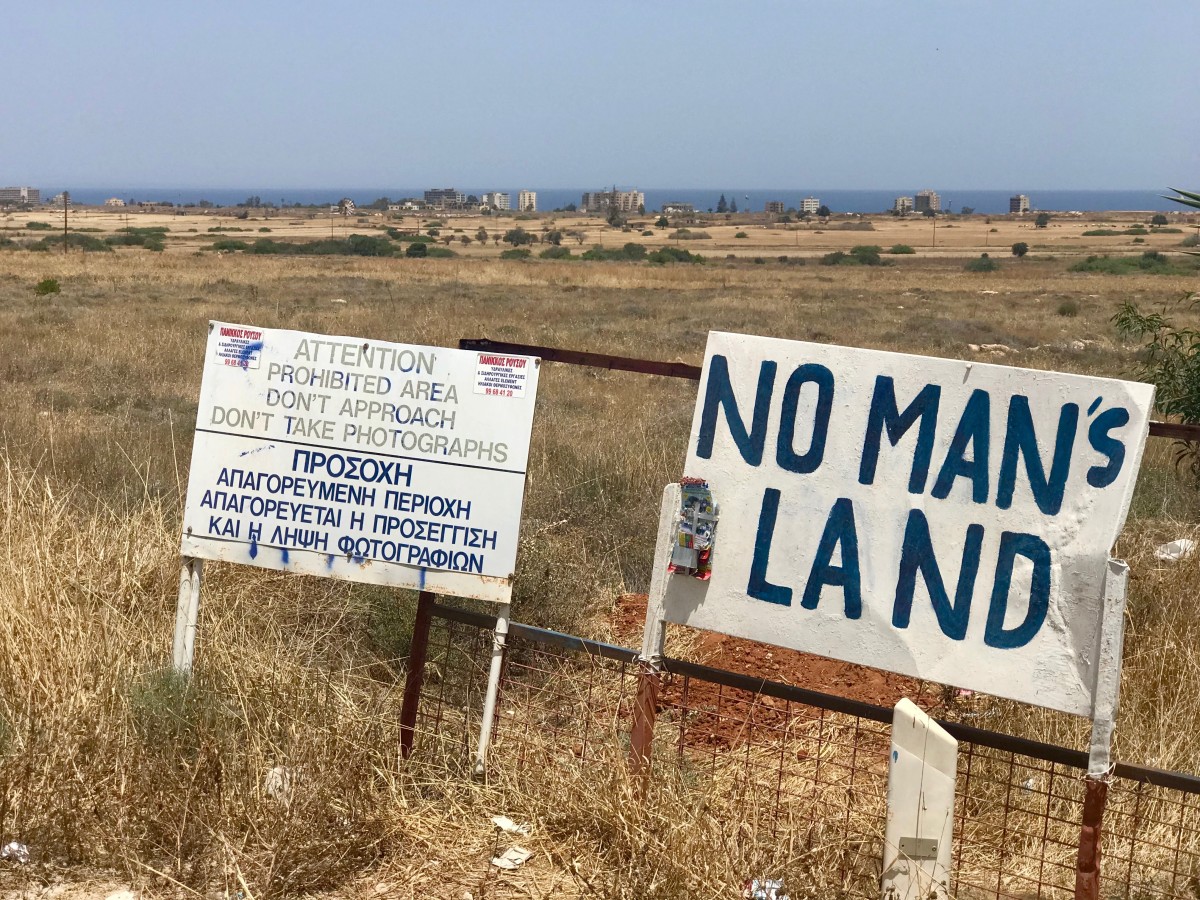 Signs mark fenced-off areas of Varosha, a quarter in the city of Famagusta, Cyprus, which until 1974 was a popular seaside resort. The buildings seen in the background are abandoned beach hotels that attracted Hollywood movie stars until the country's division.