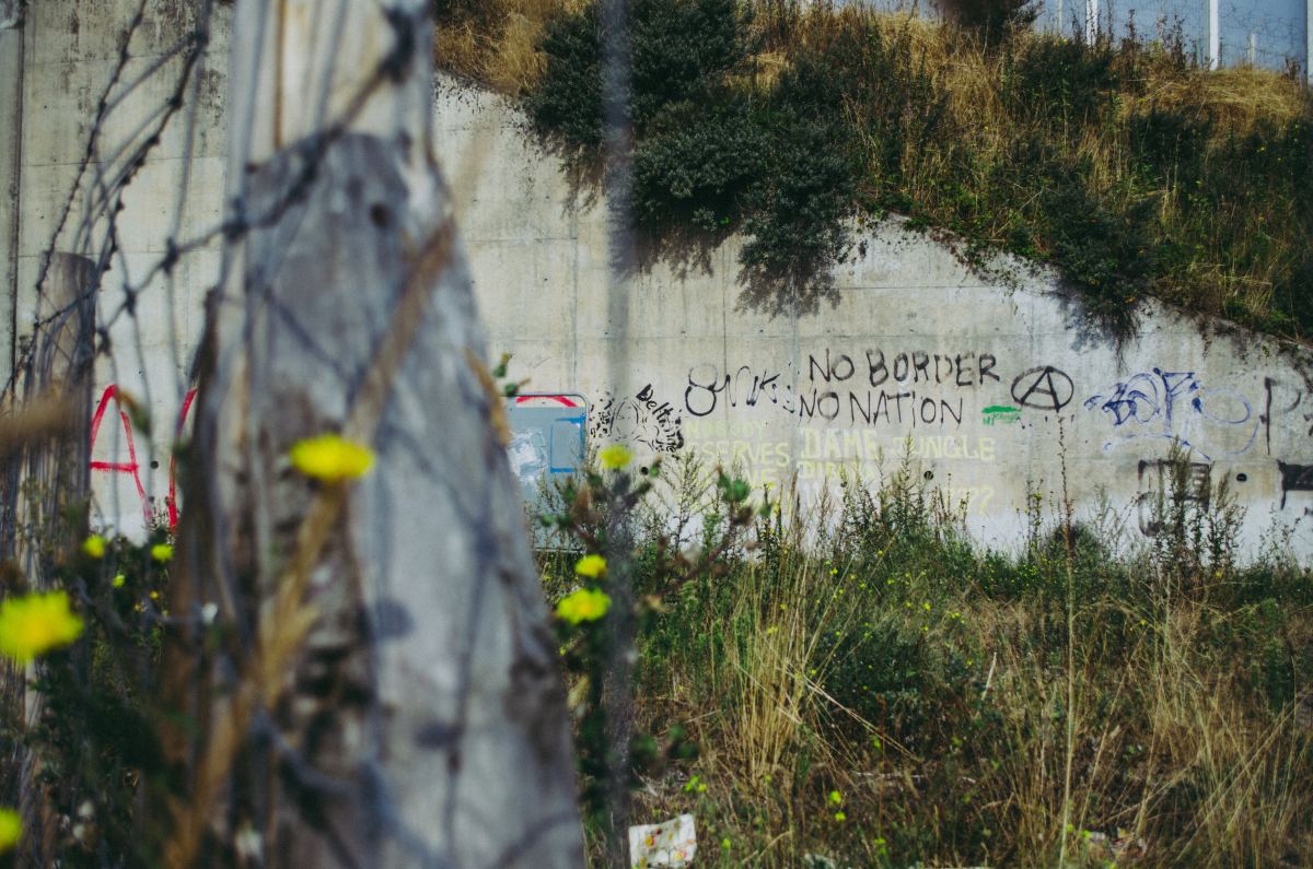 Graffiti at a deserted refugee camp in Calais, France.