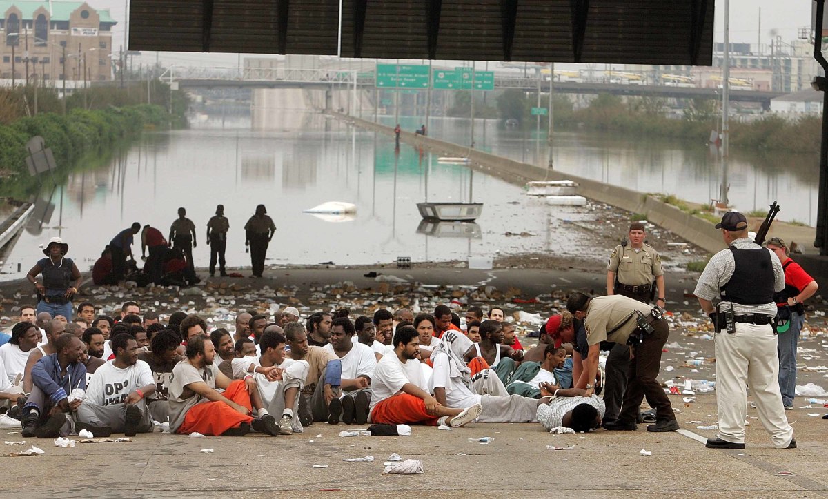 Police watch over prisoners from Orleans Parish Prison who were evacuated from their prison to the highway due to high water in New Orleans, Louisiana.