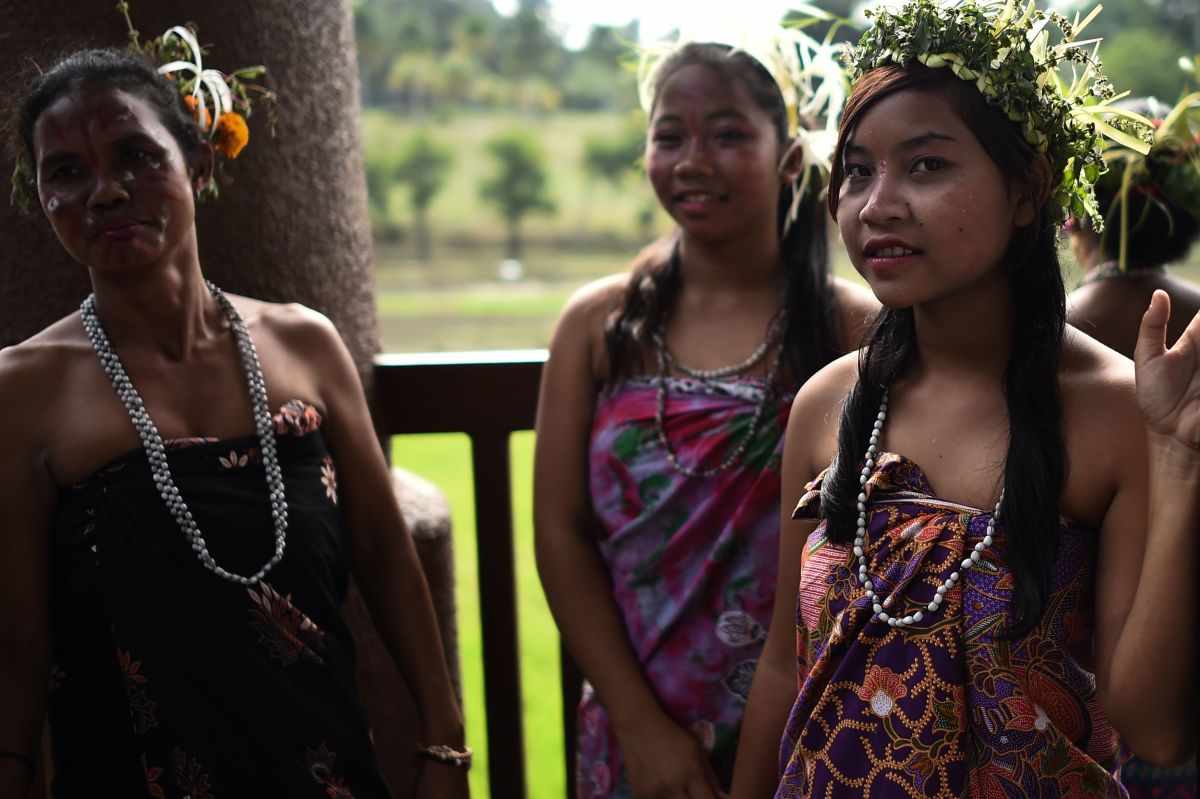Malaysian women from the indigenous Temiar community standing backstage in traditional costume and headgear before performing during a ceremony to celebrate the International Day of the World's Indigenous Peoples in Shah Alam on the outskirts of Kuala Lumpur.