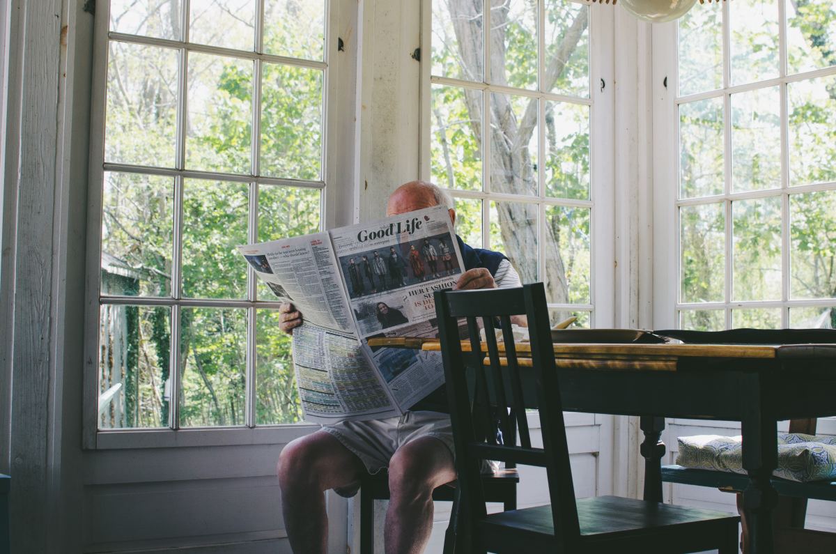 Old man reading newspaper in Cape Cod