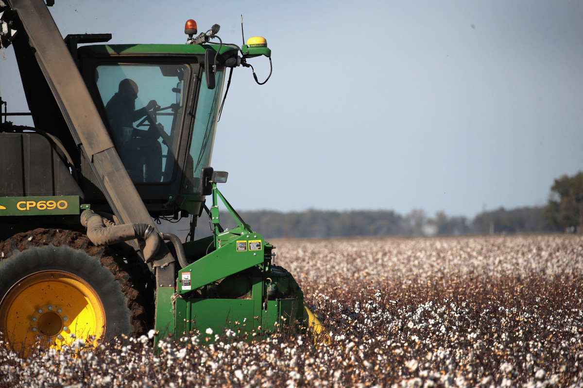 A worker harvests cotton with a John Deere cotton picker on October 30th, 2017, near Wilson, Arkansas.