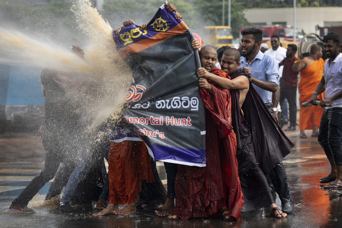 Police fire tear gas and use water cannons to disperse Sinhala extremist monks from Bodu Bala Sena on November 19th, 2018, in Colombo, Sri Lanka. The monks came to meet with Sri Lanka's president to hand over a message calling for the release of BBS General Secretary Galagoda Aththe Gnanasara Thera, who was sentenced to six years in prison. Sri Lanka's president later apologized for the severe treatment of the protesters.