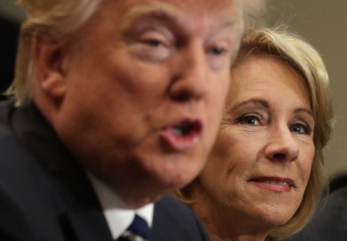 President Donald Trump speaks as Secretary of Education Betsy DeVos listens during a parent-teacher conference at the Roosevelt Room of the White House on February 14th, 2017.