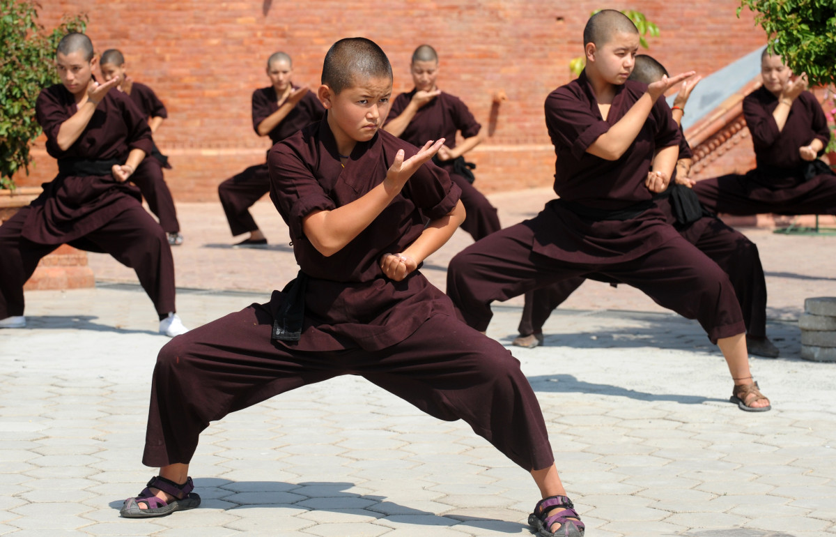 Buddhist nuns practice kung fu at the Amitabha Drukpa Nunnery on the outskirts of Kathmandu, Nepal.