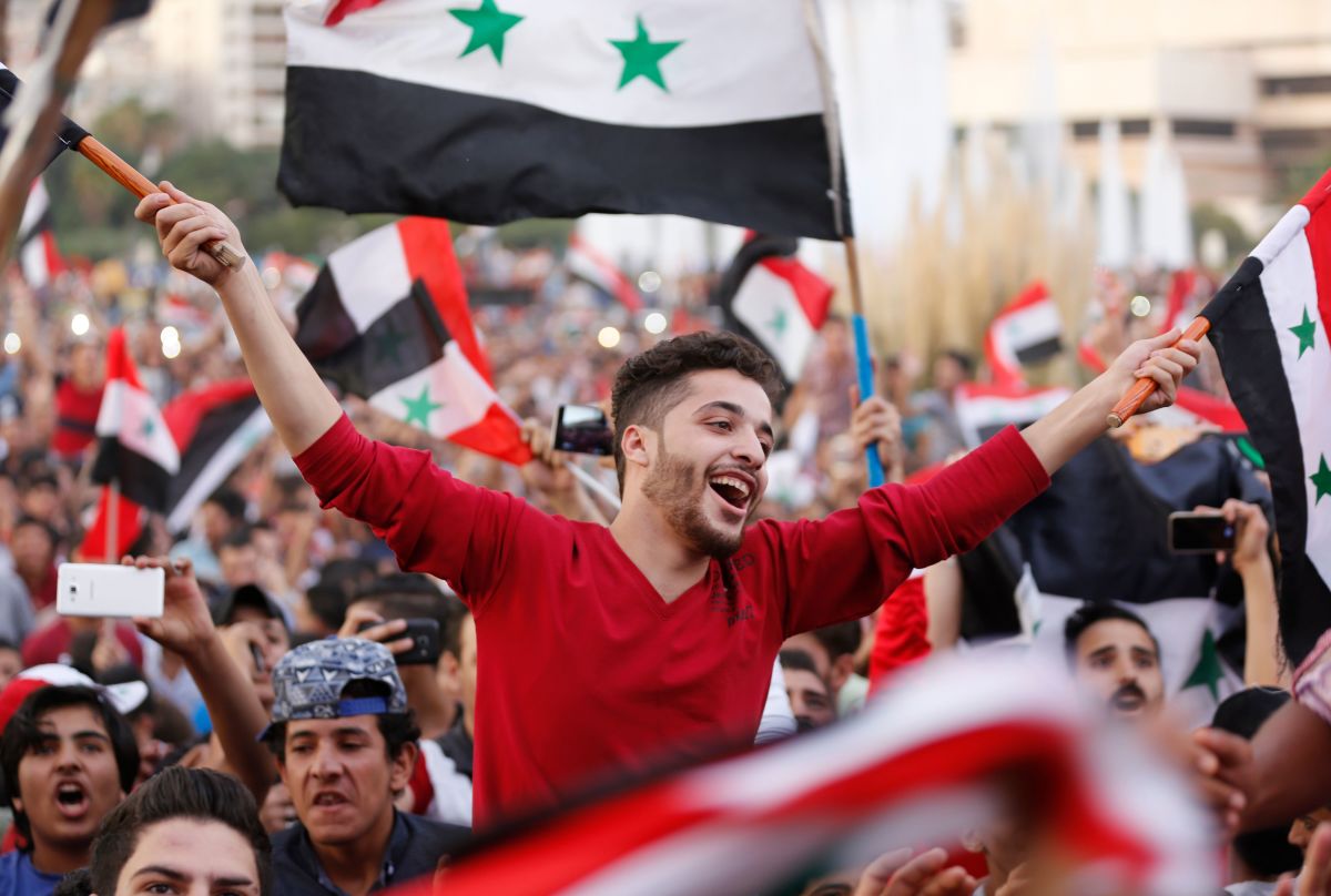 Syrians celebrate in Damascus' Umayyad Square on October 5th, 2017, after Syria's national soccer team scored in its match against Australia during the FIFA World Cup 2018 qualifier.