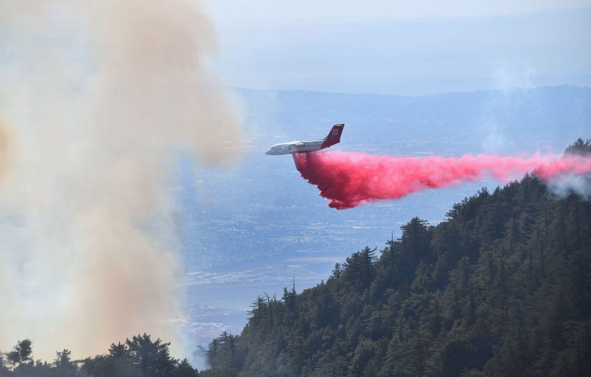 An aircraft drops fire retardant over a brush fire in the Angeles National Forest near Mt. Wilson Observatory, northeast of Los Angeles, on October 17th, 2017.