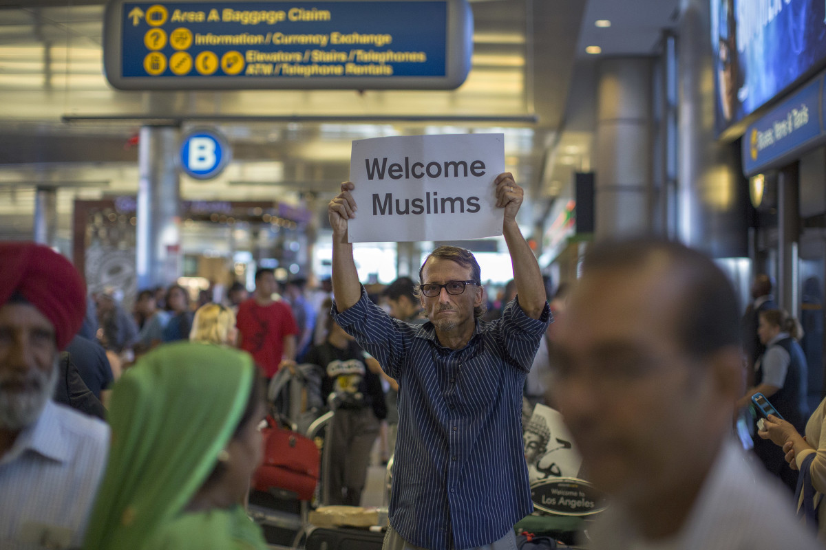 A man carries a sign welcoming Sikh travelers at Los Angeles International Airport on June 29th, 2017, in Los Angeles, California.