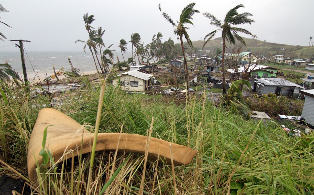 People inspect the damage from Cyclone Winston at the Namuimada settlement in Fiji on February 26th, 2016.