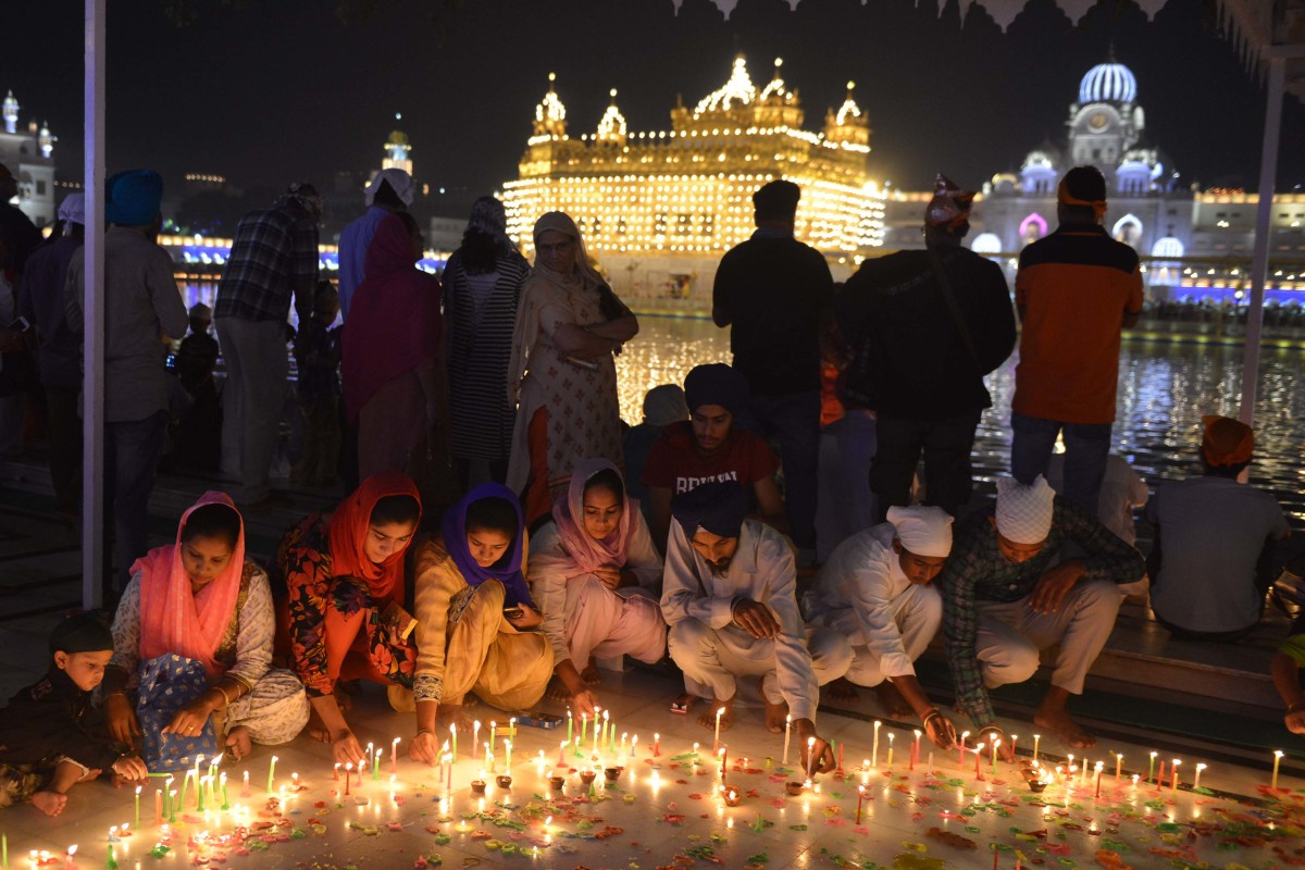 Indian Sikh devotees light candles to mark Bandi Chhor Divas, or Diwali, at the Golden Temple in Amritsar on October 19th, 2017. Also known as the festival of lights, Diwali is the biggest festival celebrated by Hindus, Sikhs, and Buddhists around the world.