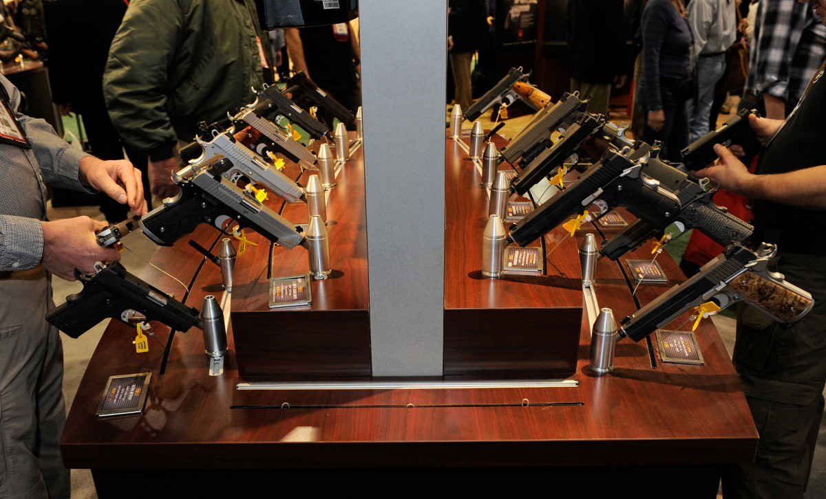 Attendees try out model pistols at a gun show on January 17th, 2012, in Las Vegas, Nevada.