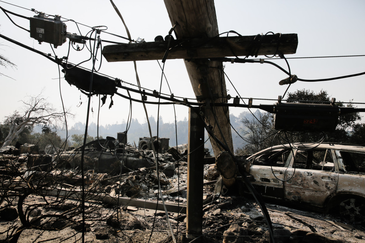 A downed power line and the remains of a home and a car are seen in the Larkfield-Wikiup neighborhood following the damage caused by the Tubbs Fire on October 13th, 2017, in Santa Rosa, California.
