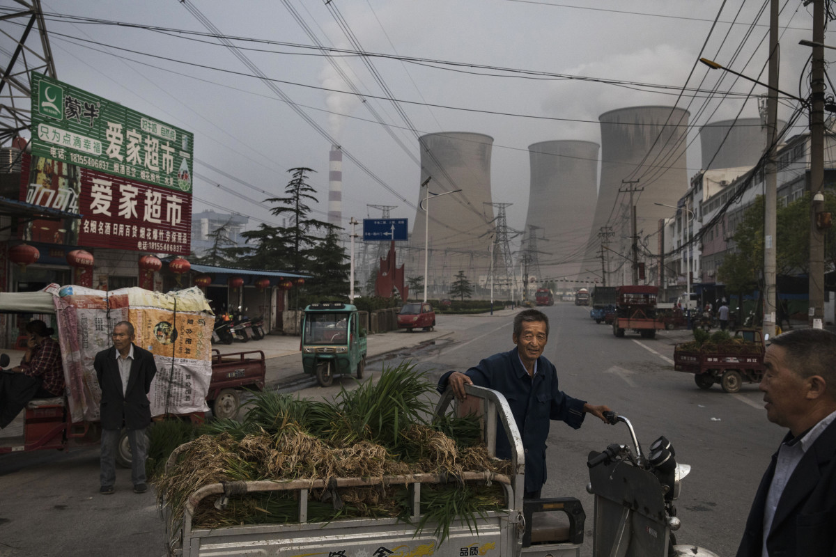 Chinese street vendors at a market outside a state-owned coal-fired power plant near the site of a large floating solar farm construction project on June 14th, 2017, in Huainan, Anhui province, China.