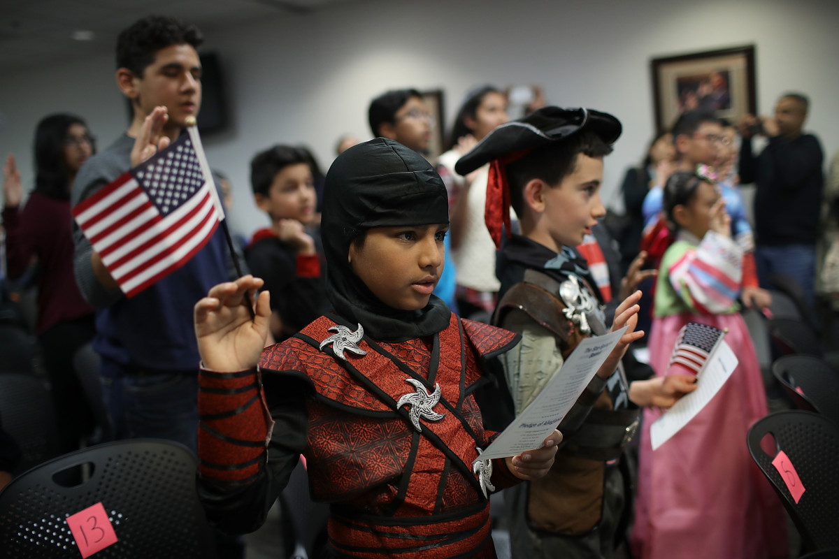 Dressed as a ninja, Shaheer Sarwar from Pakistan takes the oath of United States citizenship during a Halloween-themed citizenship ceremony on October 31st, 2017, in Fairfax, Virginia.