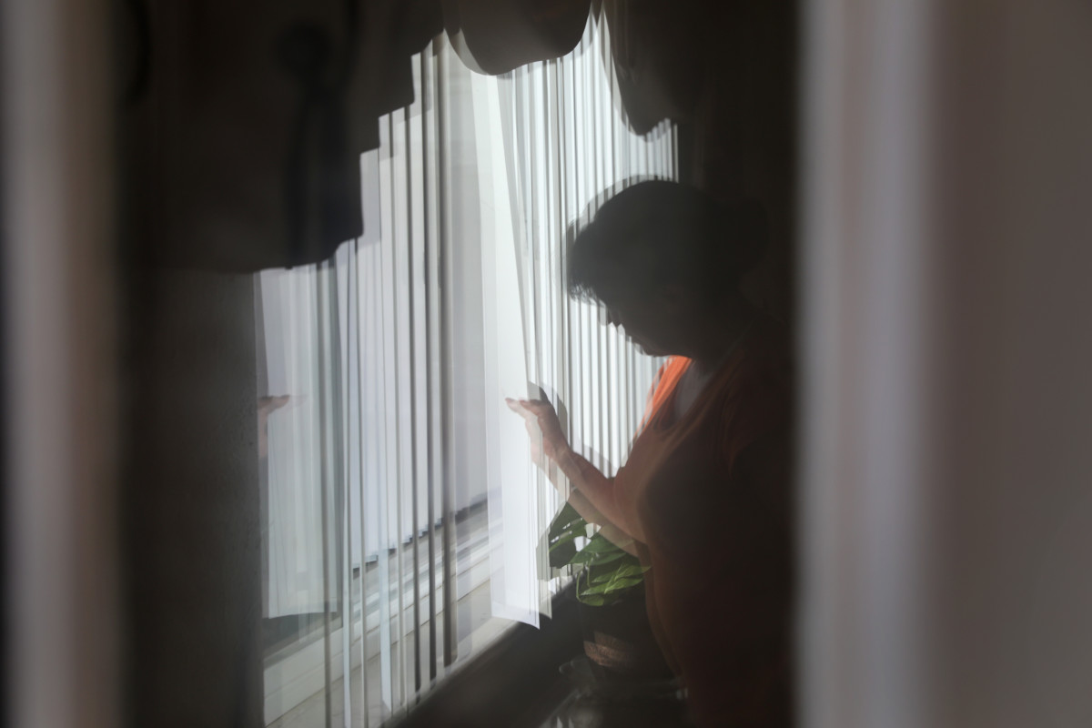 An undocumented Mexican immigrant looks out from her home on June 7th, 2017, in Denver, Colorado.