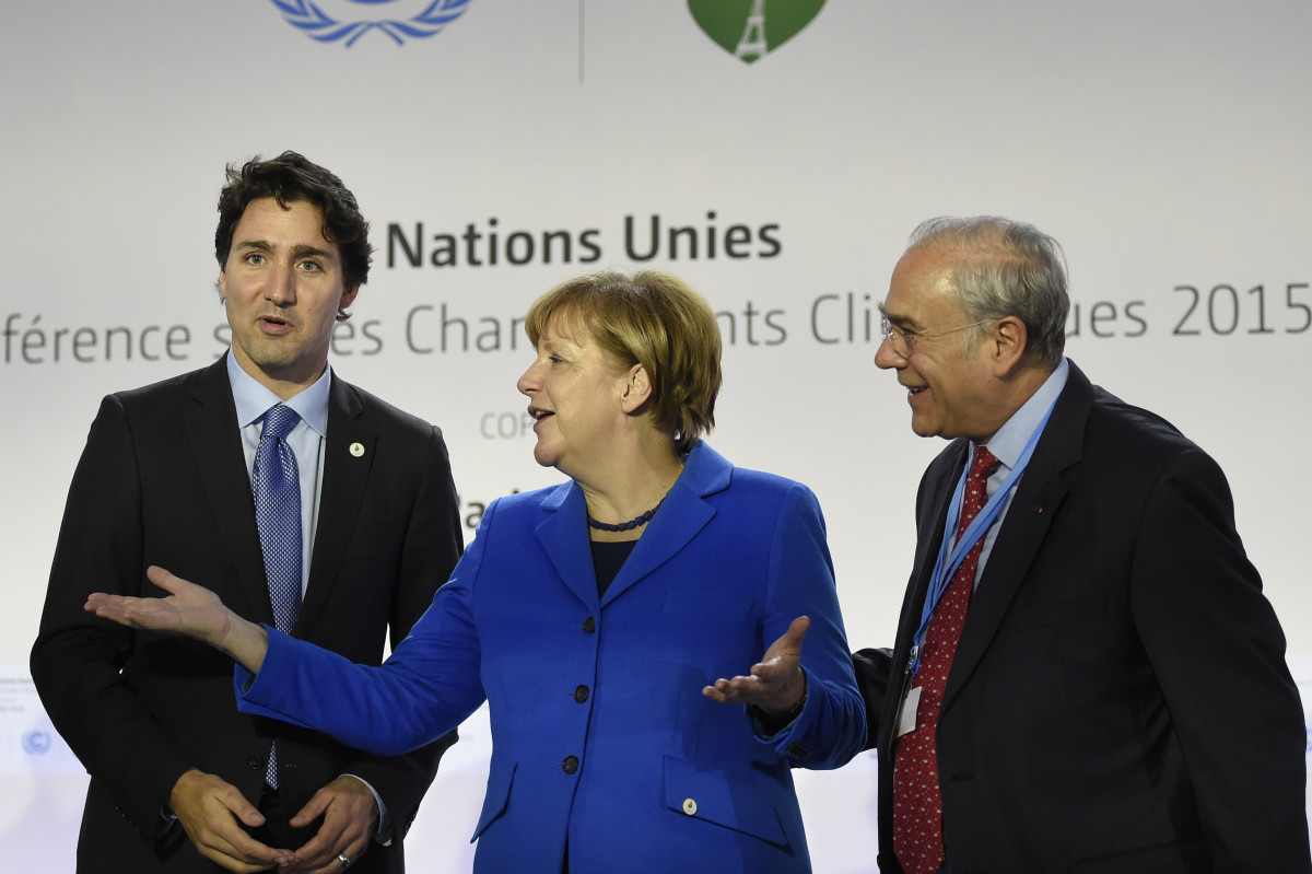 From left, Canadian Prime Minister Justin Trudeau, German Chancellor Angela Merkel, and OECD president Angel Gurria at COP21 on the outskirts of Paris on November 30th, 2015.