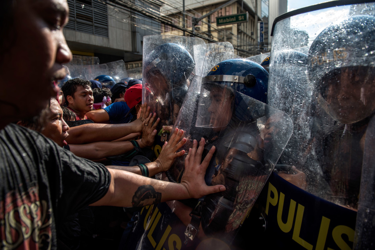 Protesters clash with riot police as they march in the streets of Manila on the day of President Donald Trump's arrival on November 12th, 2017, in Manila, Philippines.