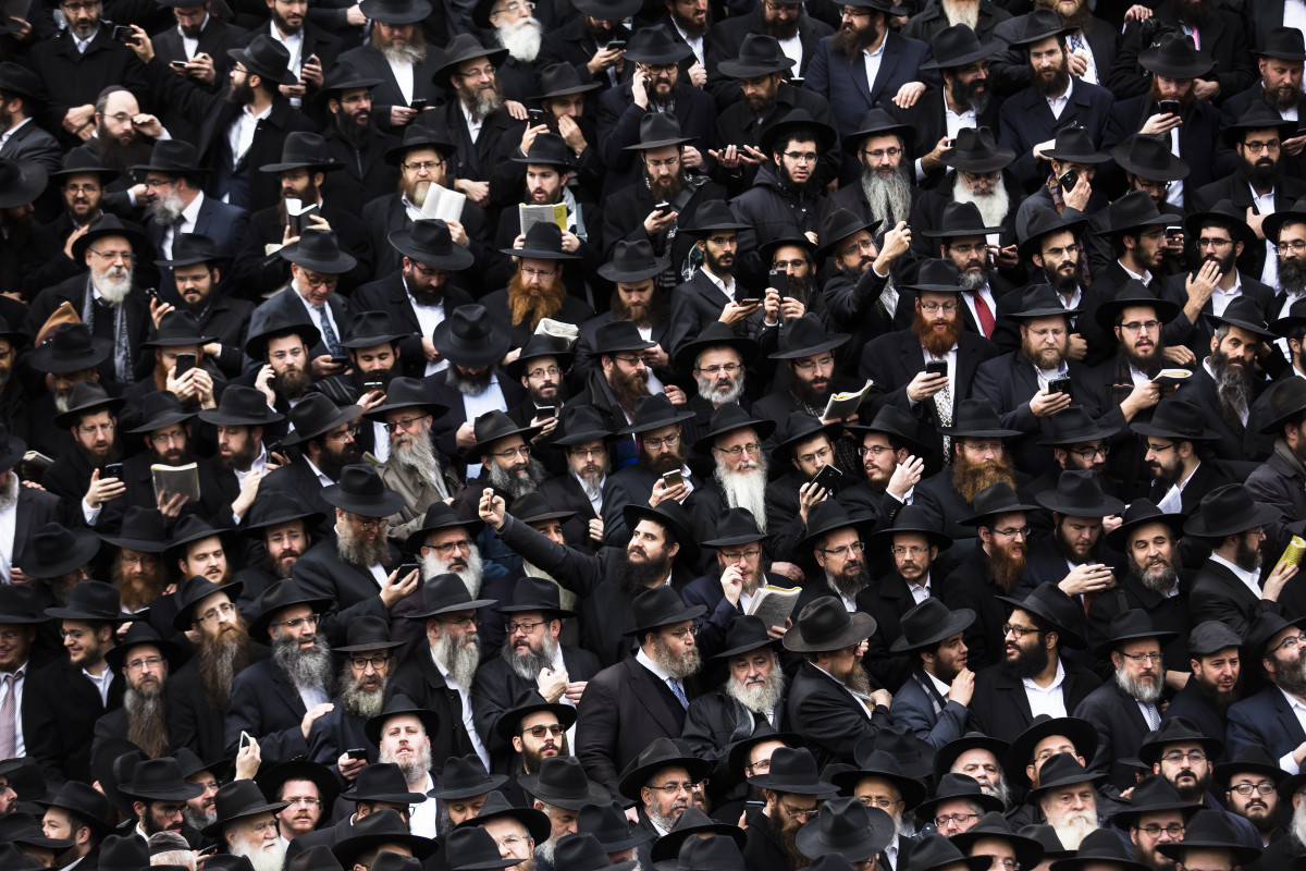 Hasidic Rabbis prepare to pose for a group photo on November 19th, 2017, during the annual International Conference of Chabad-Lubavitch Emissaries, in front of Chabad Lubavitch World Headquarters, in the Crown Heights neighborhood of Brooklyn.
