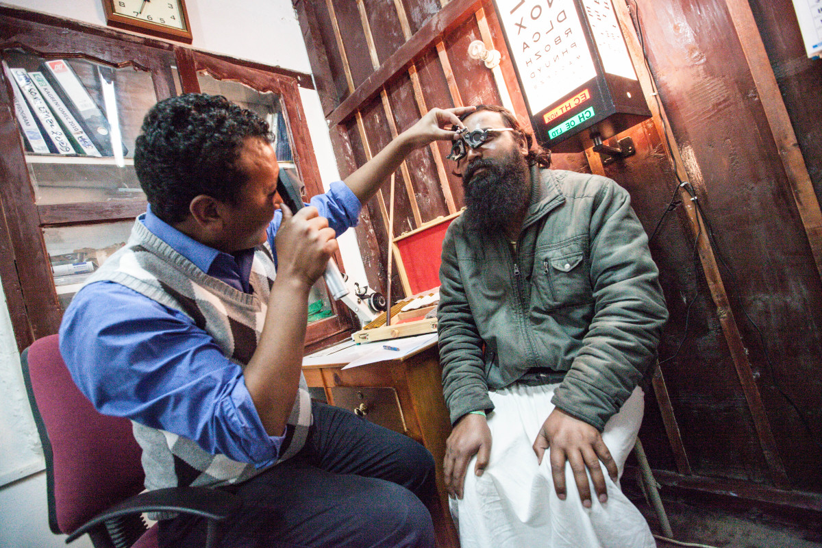 Technician Namken Lhama examines a man at the Eye Clinic in Jomsom, Mustang District, Nepal, in 2014.