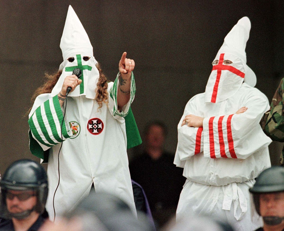 The Grand Dragon of the Michigan Ku Klux Klan (left) addresses the crowd as another Klan member looks on during a rally on August 21st, 1999, in Cleveland, Ohio.