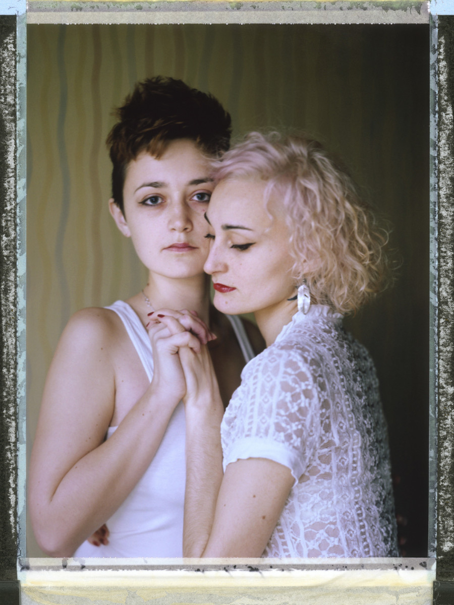 A posed portrait of lesbian couple O (27, right) and D (23, left): "After [men attacked us for being lesbians], I felt even more strongly how dear D is to me, and how scary the thought that I could lose her. The worst thing that I felt was an absolute inability to protect the one I loved, or even myself. Yes, now I look back on the street and look at every passing male as a possible source of danger. I realized that there are defective people who can pounce on us just because we are lesbians. But every time, now when I'm in the street, when I take her by the hand, I do it consciously, it is my choice. D, hold my hand, this is my reward for your courage."