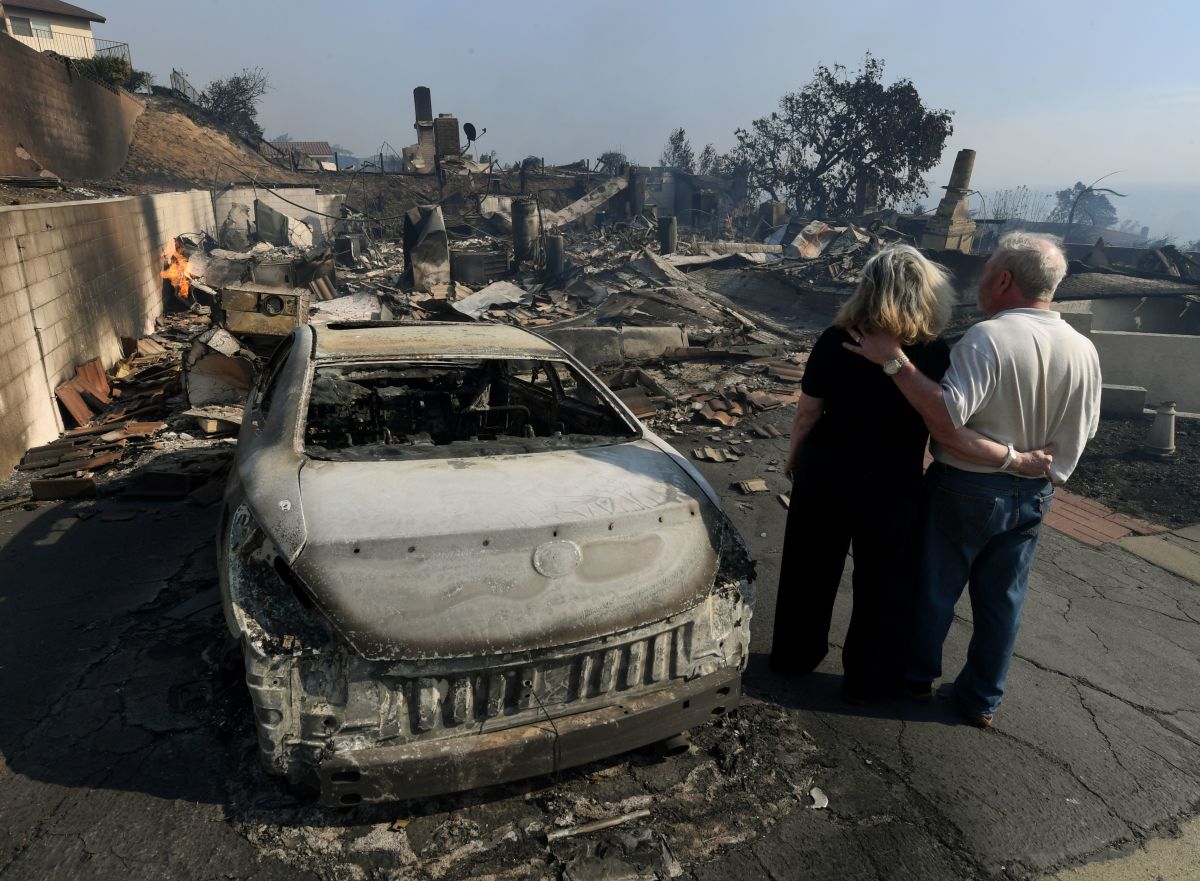 Michael and Vonea McQuillam stand beside their house that was burnt to the ground during the Thomas wildfire in Ventura, California.