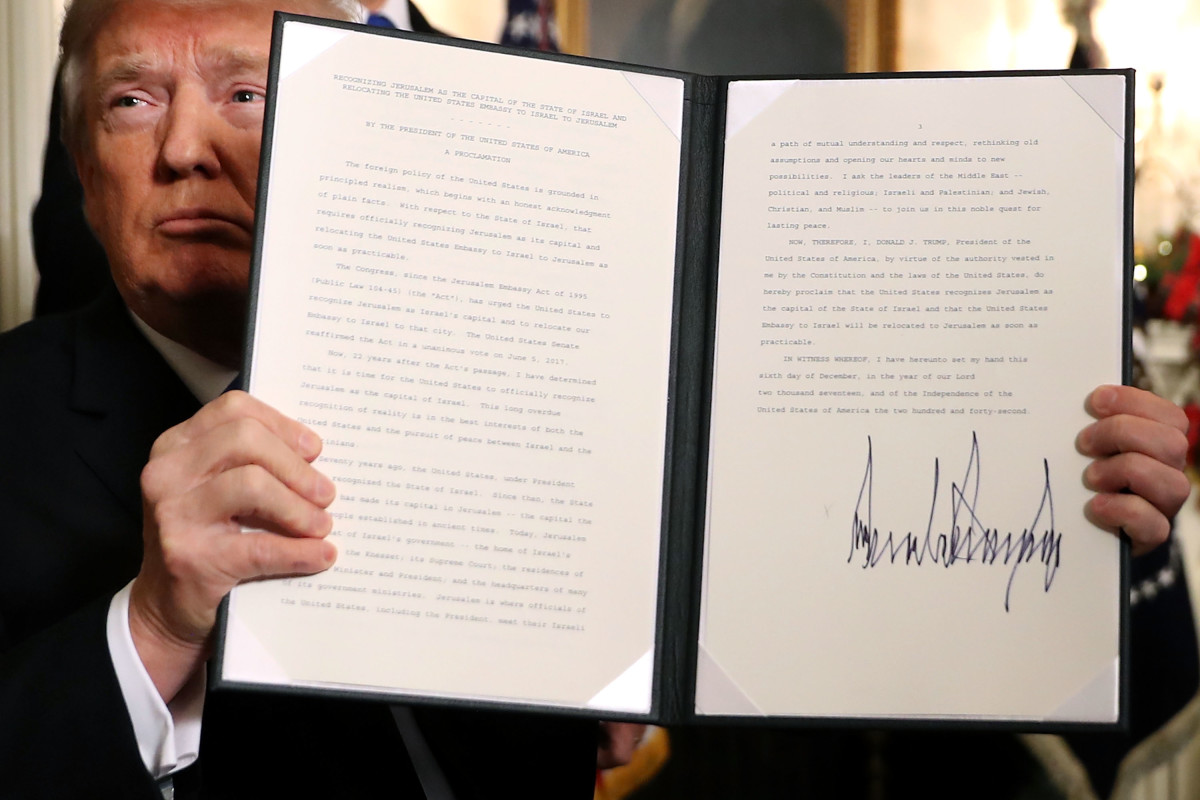 President Donald Trump holds up a proclamation signed December 6th, 2017, saying the U.S. government will formally recognize Jerusalem as the capital of Israel.