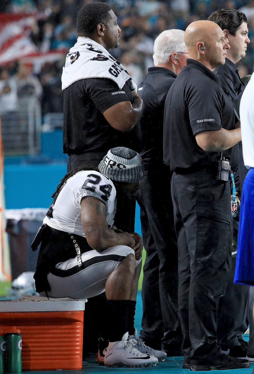 Marshawn Lynch sits during the National Anthem.