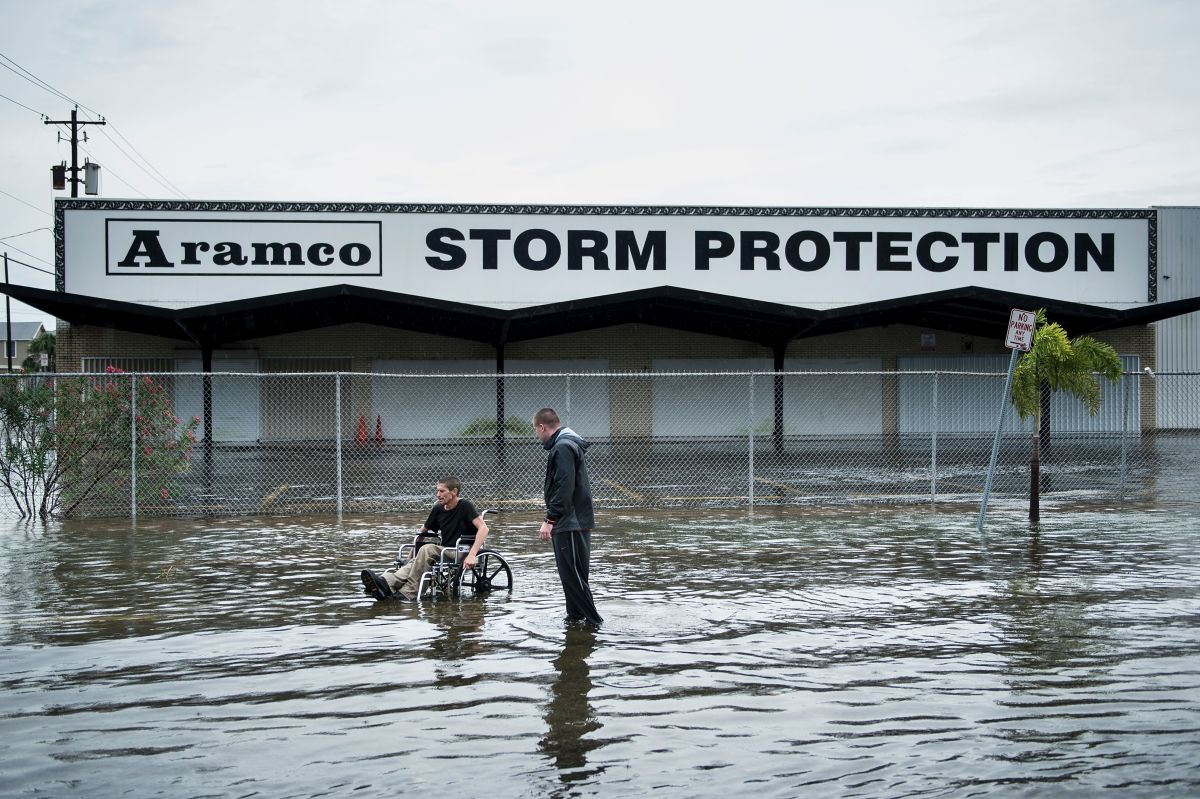 Brad Matheney offers help to a man in a wheelchair while Hurricane Harvey passes through Galveston, Texas, on August 26th, 2017.